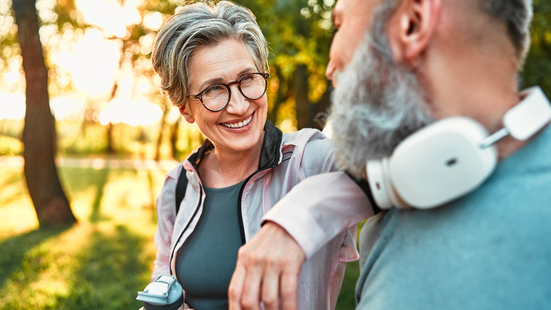 Smiling woman with a high IQ talking to a man outdoors